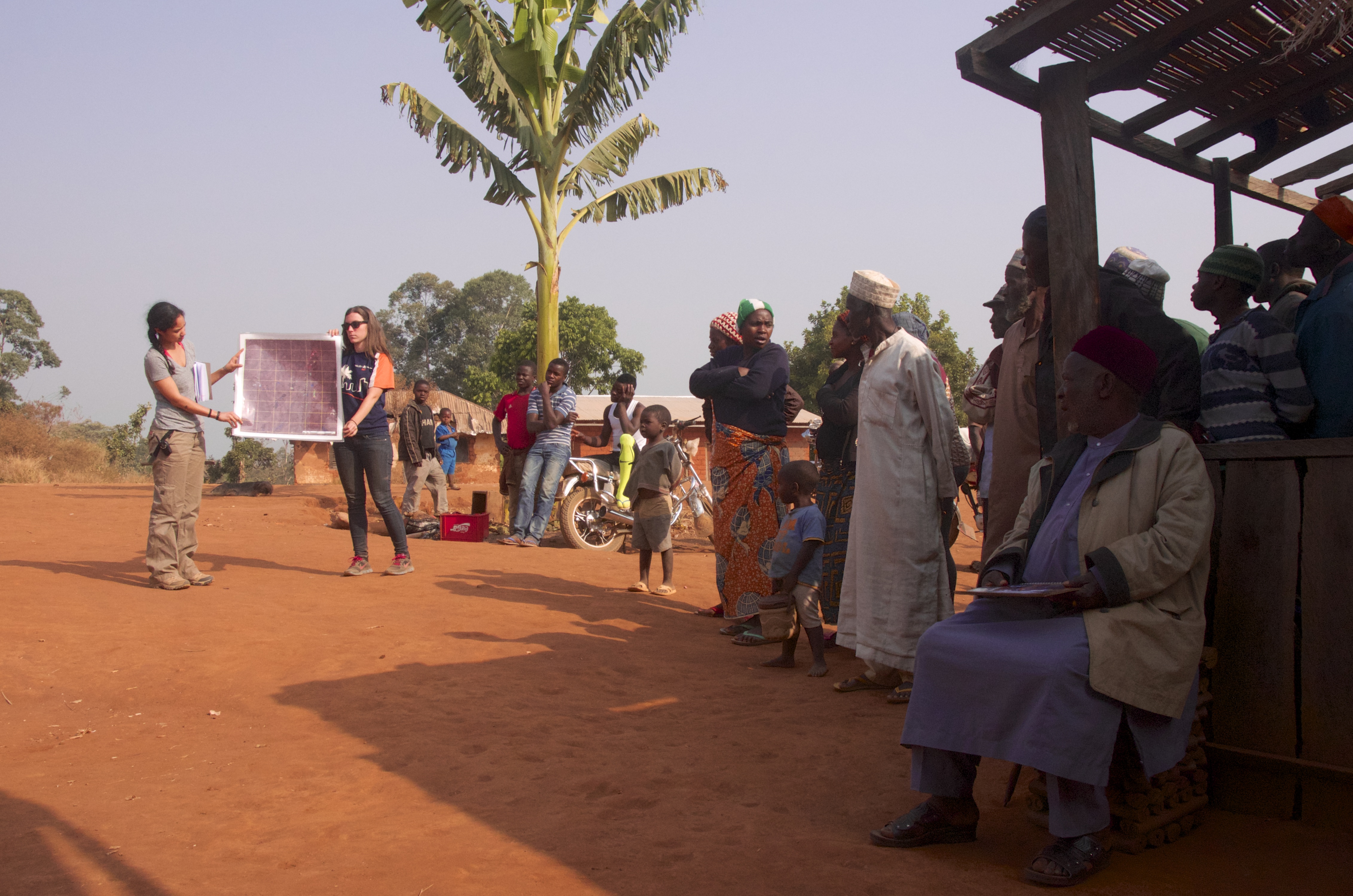 Ashley R. and Kathy communicating with the residents of Mbokop and the sub-chief (right, sitting).